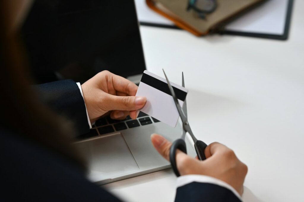 Woman cutting credit card with scissors. Bankruptcy, financial problems concept